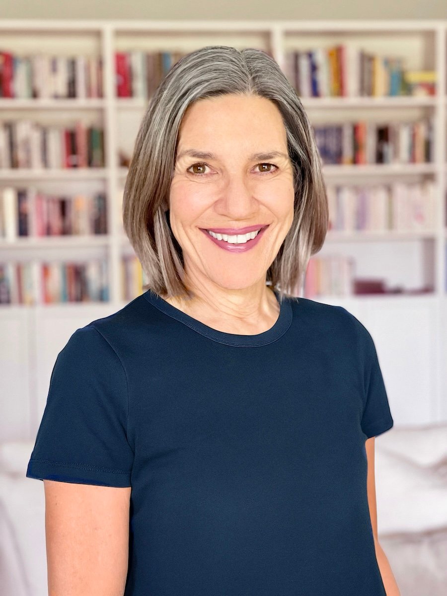 Kate James standing in front of a bookcase